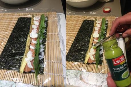 selbstgemachtes Sushi mit dem ersten Schritt, der Belegung des Nori Blattes