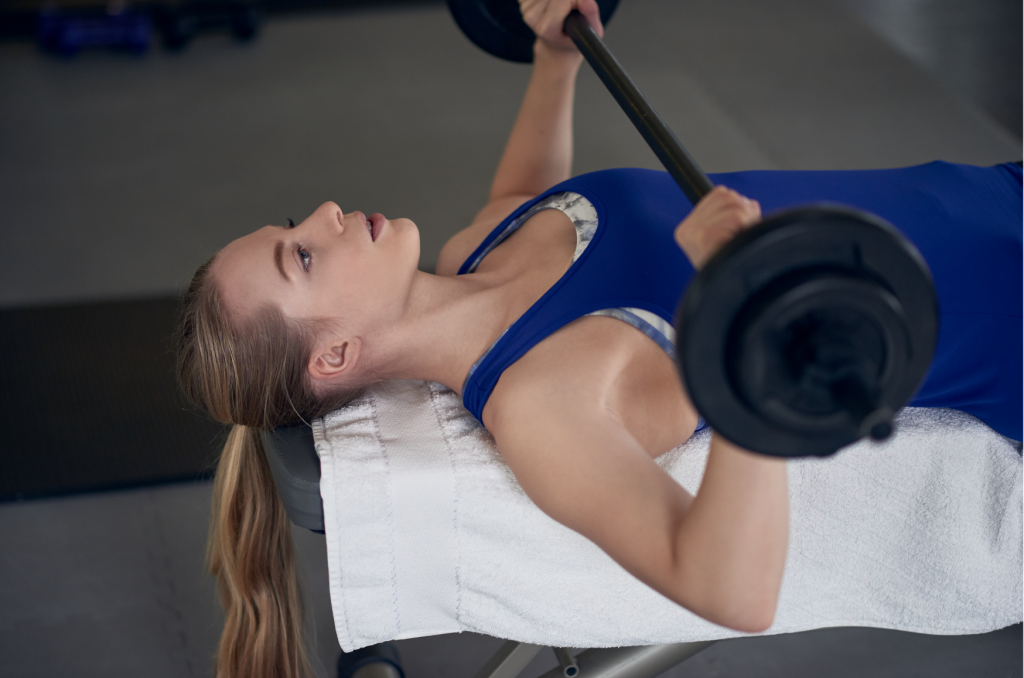 Frau macht Bankdrücken für straffe Brüste
