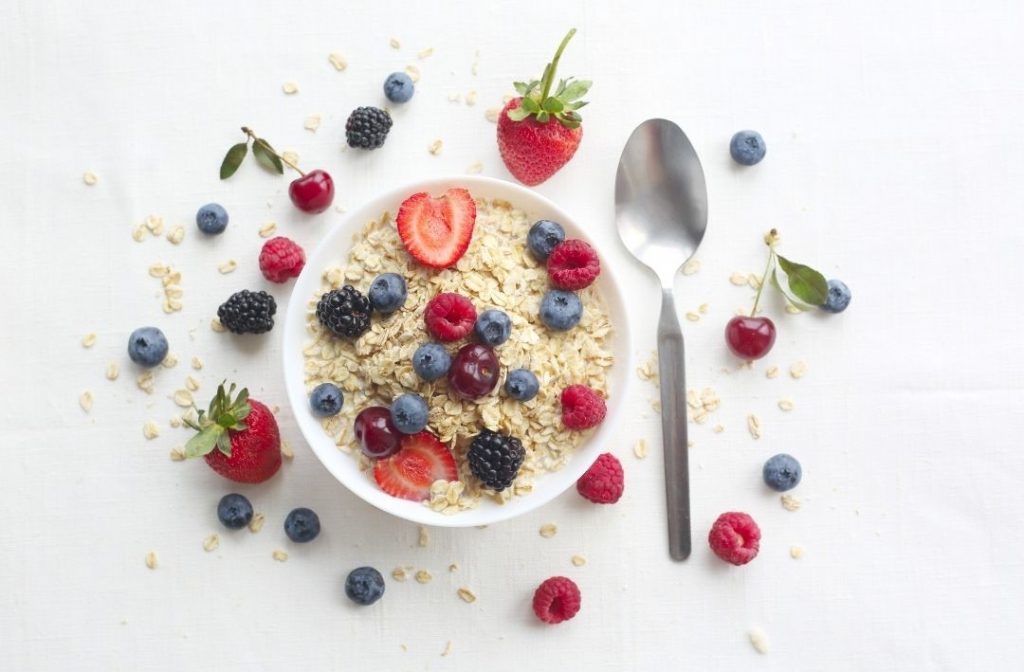 Abnehmen mit Haferflocken dargestellt als Porridge mit Beeren